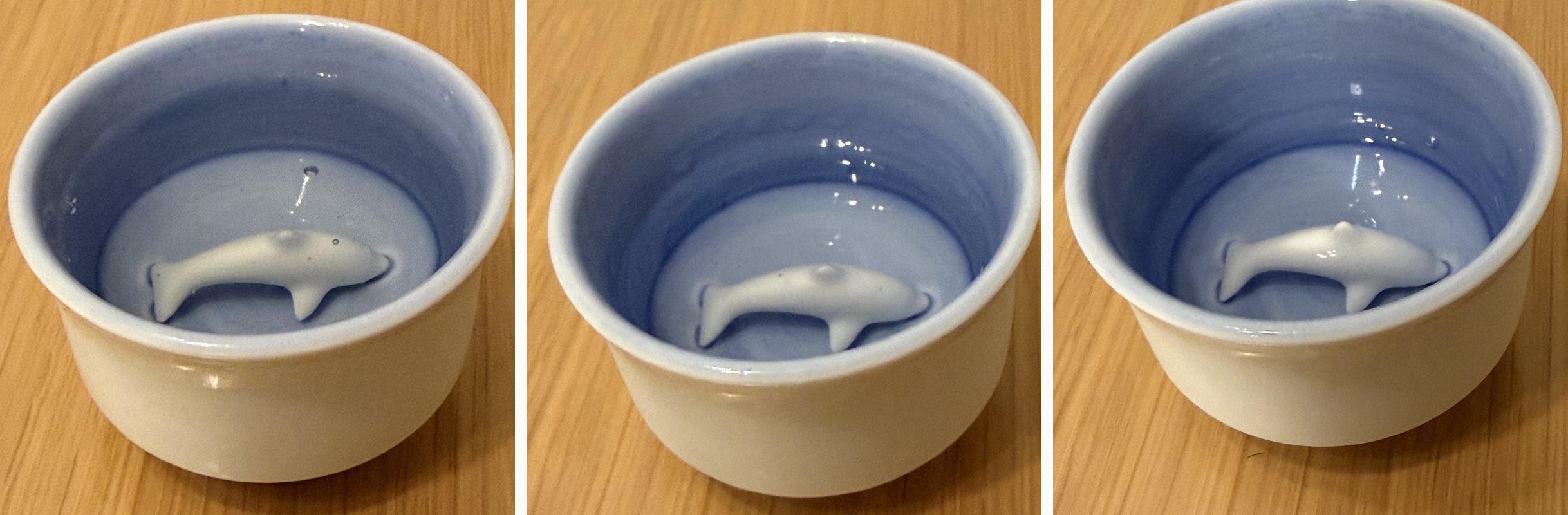 Three stages of the same pour: the dolphin partly hidden beneath the sake, becoming visible as the level falls, and clearly visible near the end